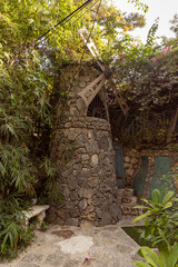 Decorative stone windmill on exhibition in the Gardens Almona collection, in the rays of the...