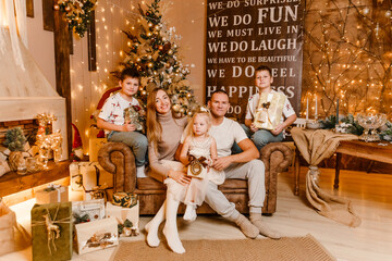 happy family of five near the tree for Christmas