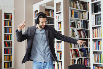 Man starting dancing in library when hearing popular music