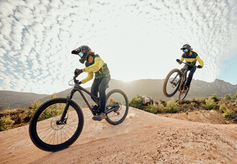 Cycling, mountain bike jump and man travel on dirt path for extreme sports adventure, journey or training for marathon race. Nature mountains, sky sun flare and freedom for fitness training cyclist