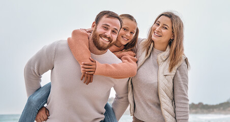 Happy family, beach vacation and summer travel with child, mom and dad together on adventure by sea with love, support and fun piggy back. Portrait of man, woman and girl outdoor by water for holiday