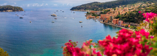 Villefranche sur Mer medieval town in South of France with bougainvillea blossom