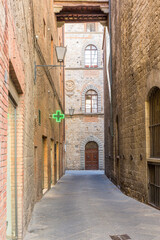 Fototapeta premium Alley with a sign to a pharmacy