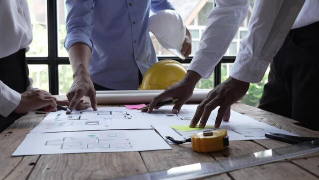 Engineer meeting for architectural project. working with partner and engineering tools on workplace.