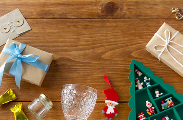Christmas ornaments, gifts and tableware on a wooden desk