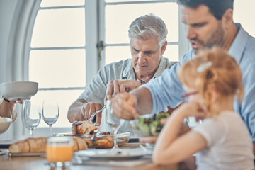 Fototapeta na wymiar Eating, dining room and senior man with his family enjoying a meal together in their modern house. Father, girl child and grandfather in retirement having food at celebration dinner, lunch or event.