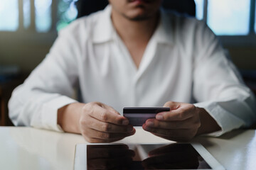 Businessman hand hold credit card pay web shopping online The promotion Black friday, Cyber monday. Shop for cheap products sale from website online stores.