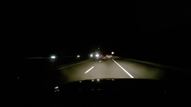 Driving down the Interstate at night.