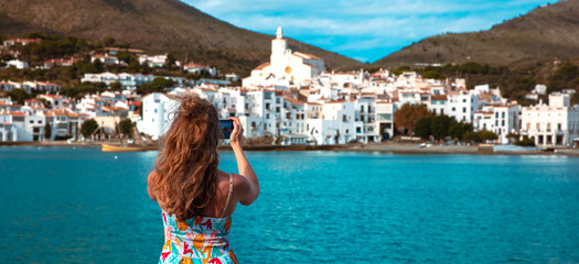 Tourist taking photography of Cadaques in Spain- Costa brava