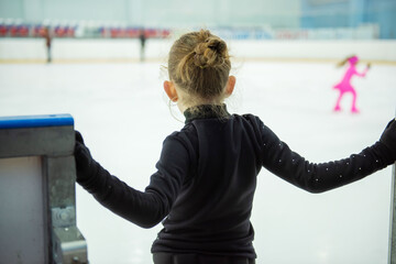 A little girl goes out to the skating rink for a lesson.