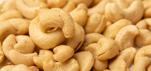 Cashew nuts as a background, top view. Cashew isolated on white background. Healthy foods.
