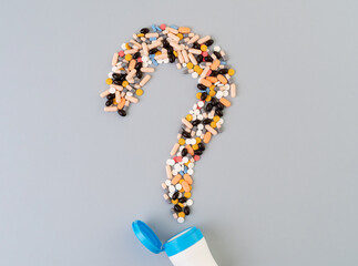 Close up photo of question mark made of pills or medicine as a symbol of antibiotics addiction....