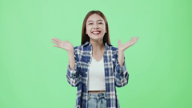 Happy beautiful delighting Asian girl looking at camera and smiling on chroma key background.