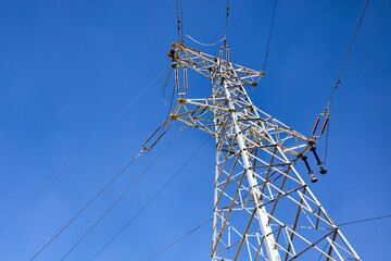 High voltage wires under blue sky