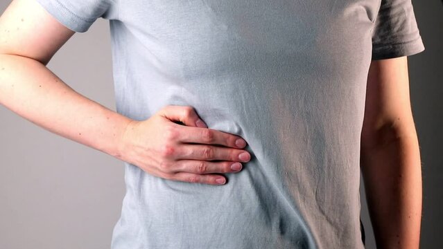 Liver pian, disease concept. Hand touching right side. Cirrhosis, cancer, chronic ache problem, closeup