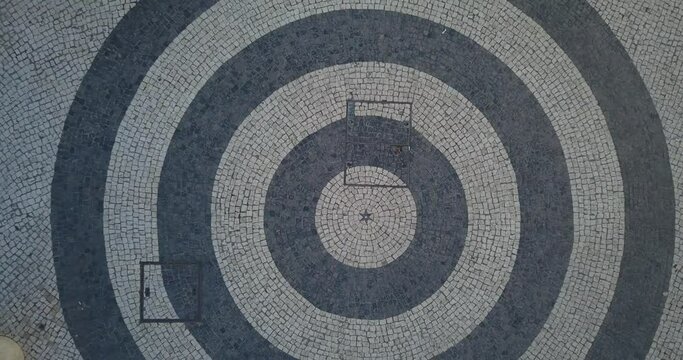 Top View of the Mosaic World Map showing the Diana arch and tourists visiting at rossio square, Lisbon, Portugal