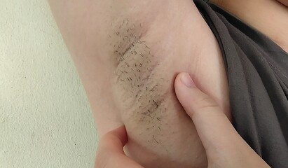 Fototapeta premium Portrait showing the fingers holding the flabbiness adipose and flabby skin under the arm, problem wrinkled and flabby skin, armpit hair underarm of the woman, concept health care and beauty.