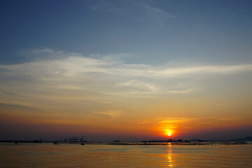 Sunset sky at sea with silhouette of island background