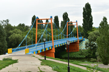 A blue metal bridge connecting the two banks.