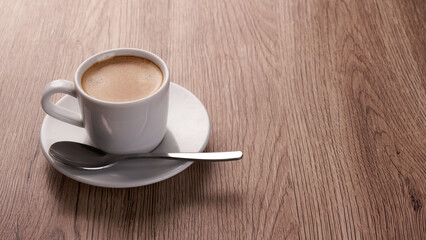 A cup of coffee on a wooden counter. Espresso.