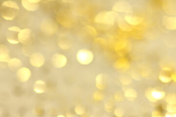 Abstract background with golden glittery bokeh.