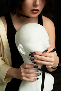 Women's hands cover the mouth of the mannequin. You can't talk. Remaining silent. Prohibition