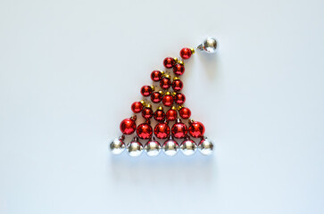 Colorful baubles ornament set as santa claus hat on white background. Mimimal Christmas holiday concept.