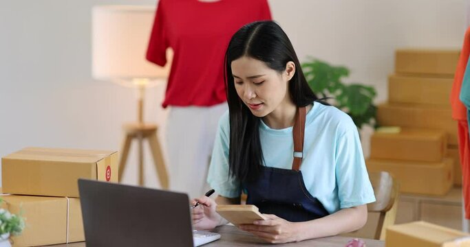 Portrait young attractive hipster asia female owner startup work happy with box at home prepare parcel delivery in sme supply chain, procurement, Asian omnichannel Sme ecommerce online concept.