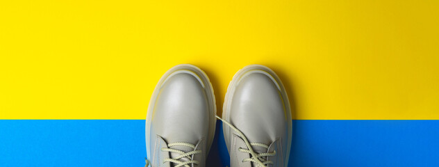 beige women's shoes on a colorful background. Autumn shoes. Horizontal image