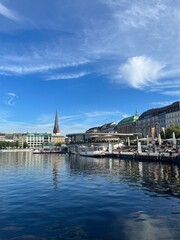 Fototapeta premium Buildings reflection on the lake surface, blue city lake 