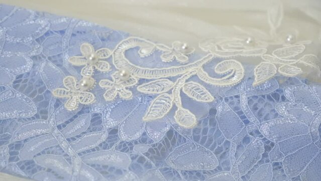 Lace Floral Pattern Texture Fabric with Beads. Close up of white blue wedding dress lace and fabric