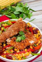 Mexican Chicken, corn and bean salad on rustic white wooden table with copy space