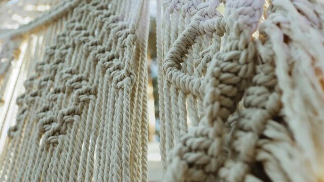 Decorated wedding arch. Wedding ceremony in the woods. Macrame. Slow motion shot.