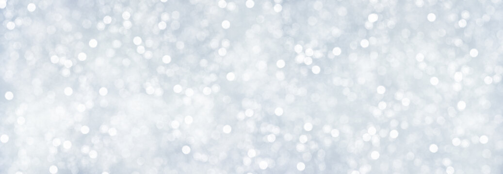 Panorama of decorative Christmas background with bokeh lights and snowflakes.