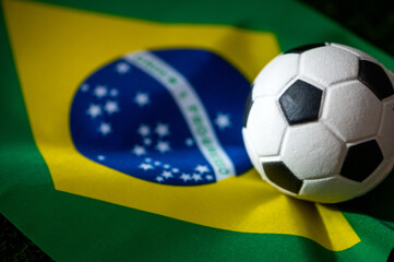 Naklejka premium Brazil national football team. National Flag on green grass and soccer ball. Football wallpaper for Championship and Tournament in 2022. World international match.