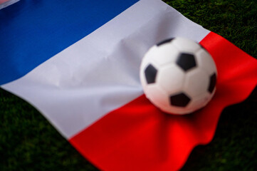Naklejka premium France national football team. National Flag on green grass and soccer ball. Football wallpaper for Championship and Tournament in 2022. World international match.