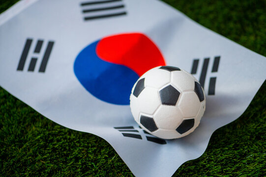 South Korea national football team. National Flag on green grass and soccer ball. Football wallpaper for Championship and Tournament in 2022. World international match.