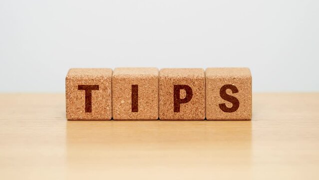 TIPS / four wooden blocks with the letters Tips on the wooden surface