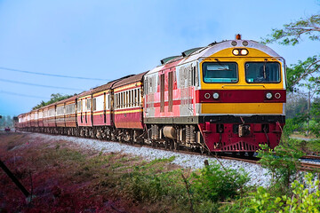 Fototapeta premium Passenger train by diesel locomotive on the railway.