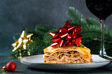 Piece of tasty hot lasagna on light background. Traditional italian lasagna. Italian food. Close up...