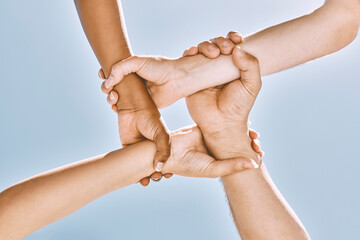 Wrist hands, teamwork and diversity, support or community, trust or cooperation on blue sky....