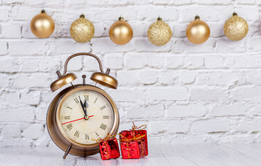 alarm clock, Christmas tree, gifts Christmas toys on the background of a brick wall