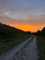 Fototapeta na wymiar Orange sunset in the rural field 