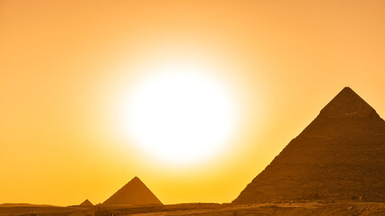 Great Pyramids of Giza from Cairo in an amazing sunset light, landmark historical construction buildings from Egypt.