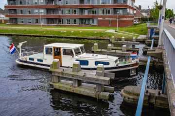 Recreational boat on a canal in the Netherlands on a cloudy summer day. Water.