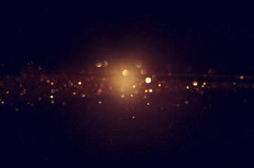 background of abstract glitter lights. gold and black. de focused