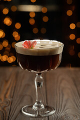 Espresso Martini cocktail in glass with coffee beans. Alcoholic coffee cocktail with liqueur. Easy Bartenders Recipes