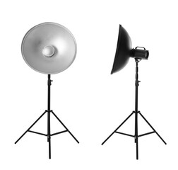 Studio flash lights with reflectors on tripods against white background
