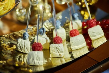 Delicious and mouth-watering canapes with cheese. Decoration for a festive table