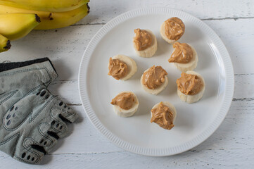 Healthy fitness snack with sliced banana and crunchy peanut butter topping